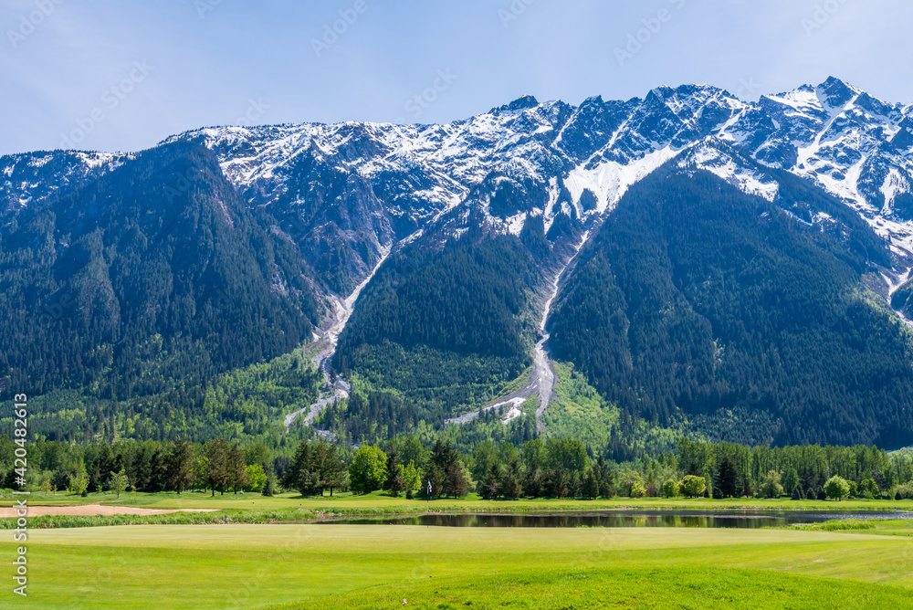 Golf course with gorgeous green and fantastic mountains view.