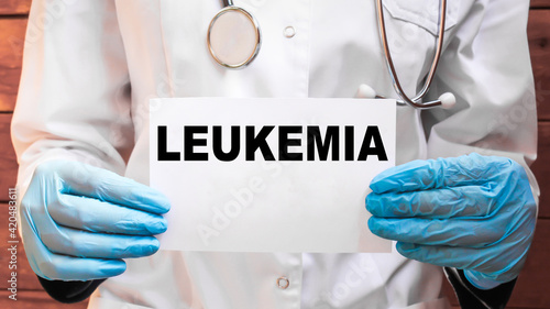 The doctor s blue - gloved hands show the word LEUKEMIA - . a gloved hand on a white background. Medical concept. the medicine