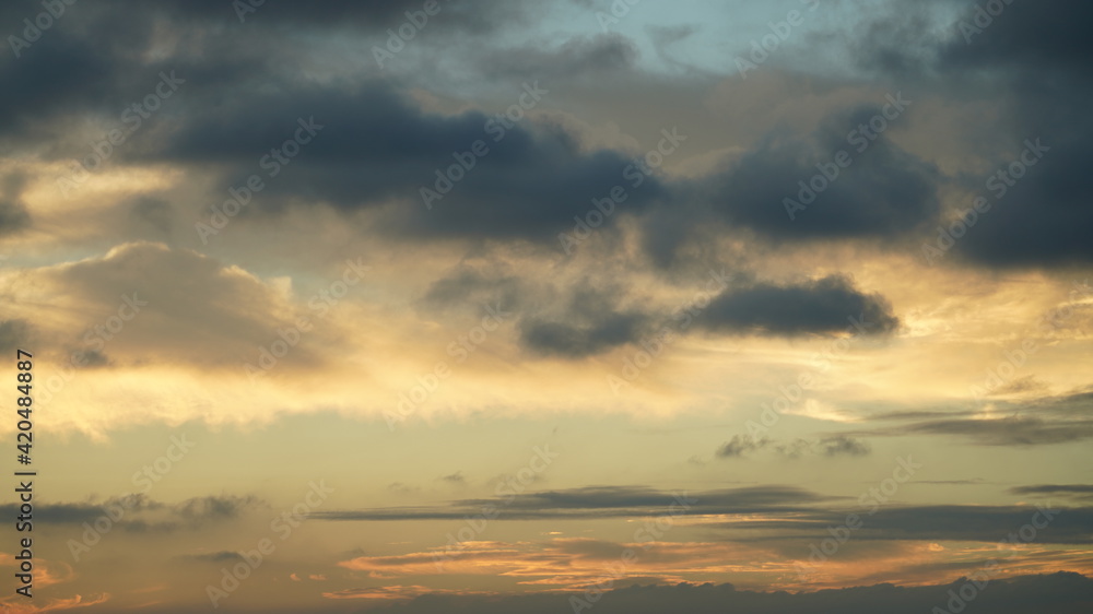 The beautiful sunset sky view with the colorful clouds and blue background
