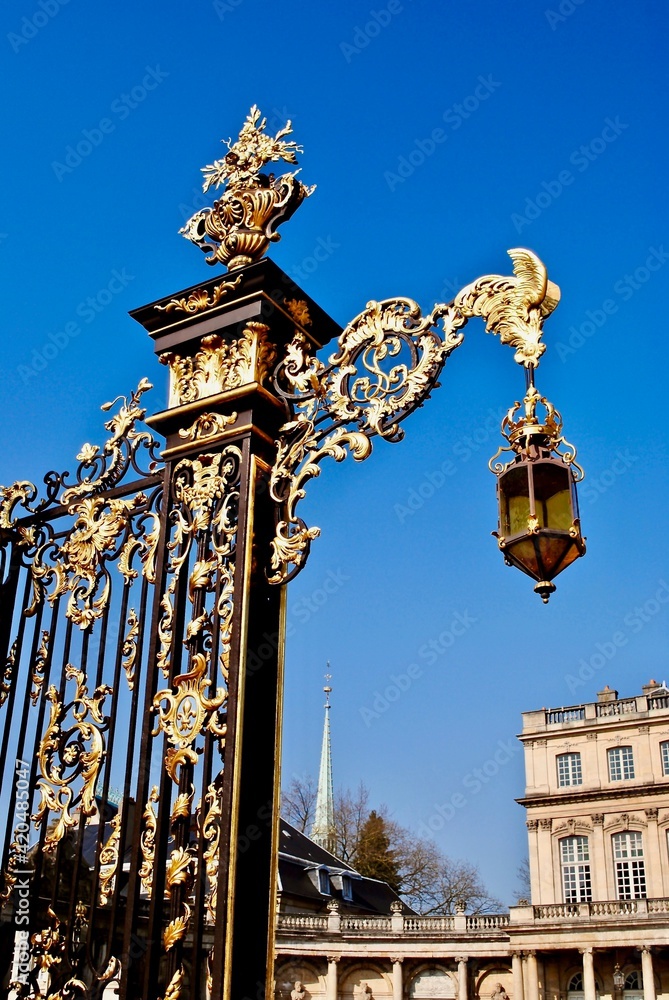 Gilded wrought iron gates and lantern by Jean Lamour at Place Stanislas in Nancy, France. Covered in gold leaves and displaying Louis XV’s royal ciphers (laurel branch, roosters) and fleurs-de-lis.