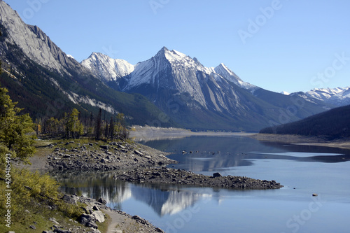  Alberta, Canada the Rocky mountains and the forest reflected in the lake water