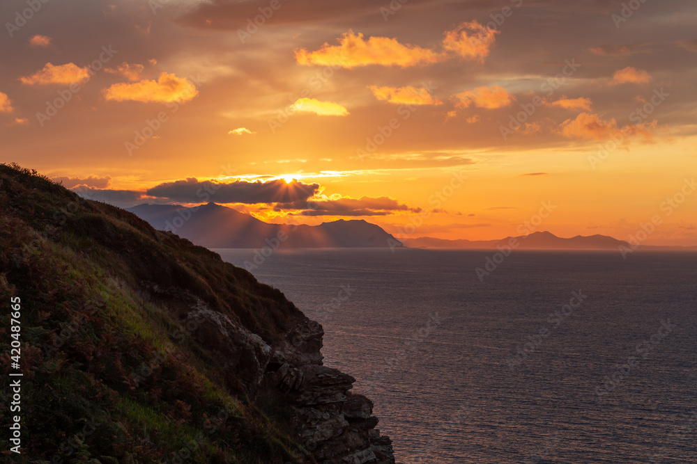 beautiful and colorful sunset views from a cliff next to the sea