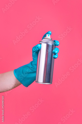 Hand holding a spray can
