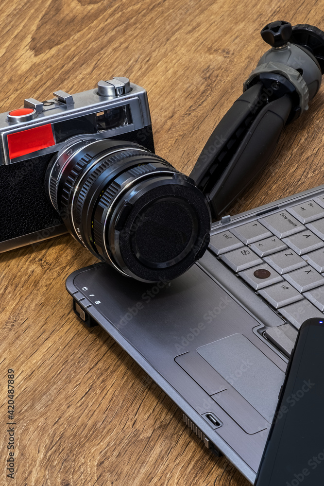 Composition of a laptop, a mobile and an old camera