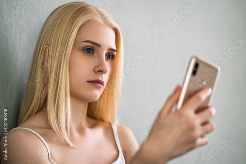 Young woman using smart phone on the bed