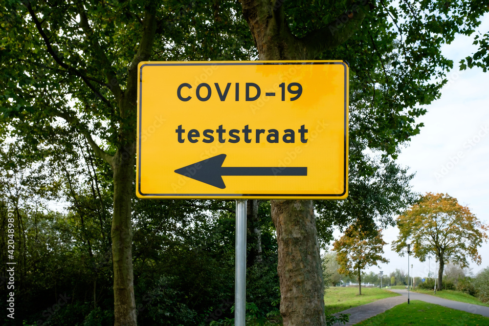 Corona test street direction sign in The Netherlands. Translation (Dutch):  