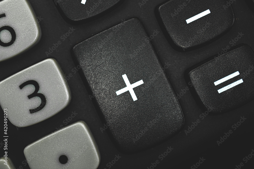 Plus sign and symbol, calculator button close-up Plus sign and symbol, calculator button close-up