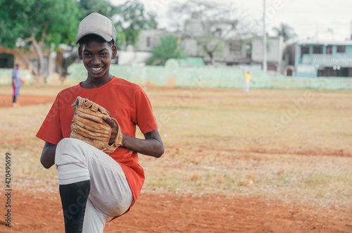 Photography boy with brown skin and latin origin playing baseball in the park with ball, glo