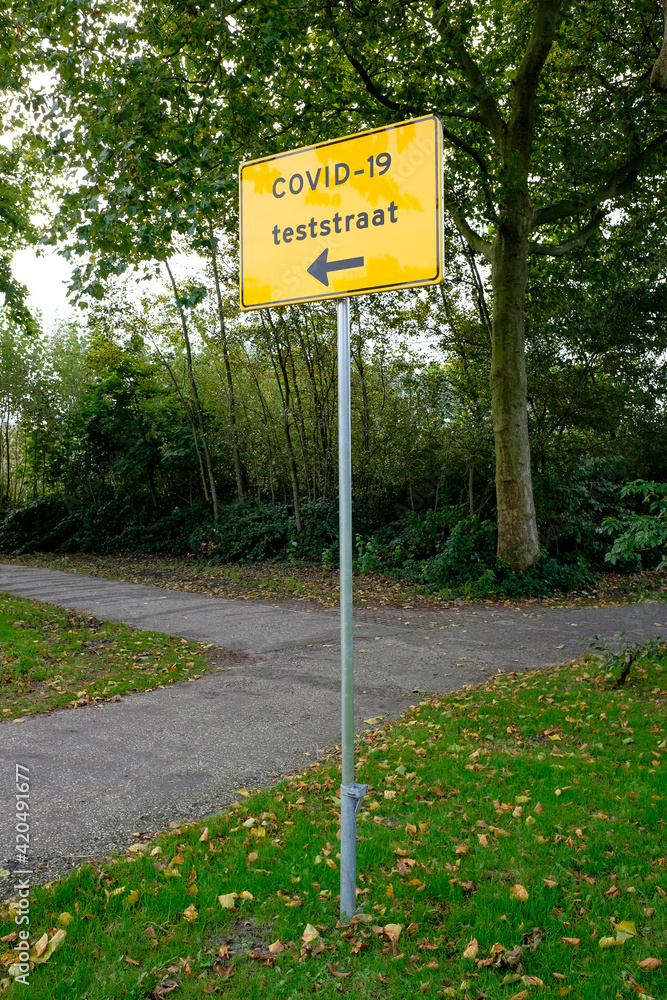Corona test street direction sign in The Netherlands. Translation (Dutch): Corona test street direction sign in The Netherlands. Translation (Dutch):