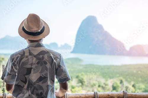 Happy traveler man enjoy Phang Nga bay view point, alone Tourist relaxing at Samet Nang She, near Phuket in Southern Thailand. Southeast Asia travel, trip and summer vacation concept © Jo Panuwat D