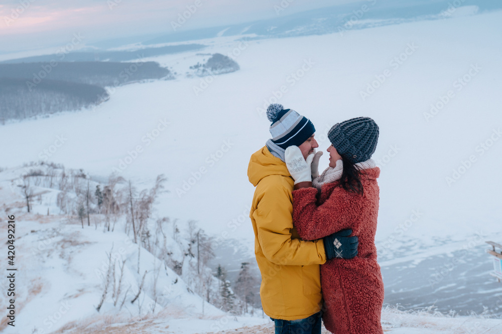 Winter love story. Young couple having fun on the frozen lake Winter love story. Young couple having fun on the frozen lake