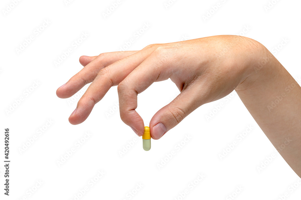 Hand holding capsule pill isolated on white background ,include clipping path Hand holding capsule pill isolated on white background ,include clipping path