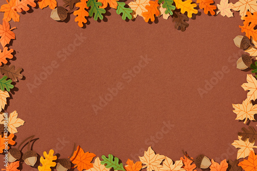 Frame of yellow maple leaves, red oak leaves, pear and acorns photo