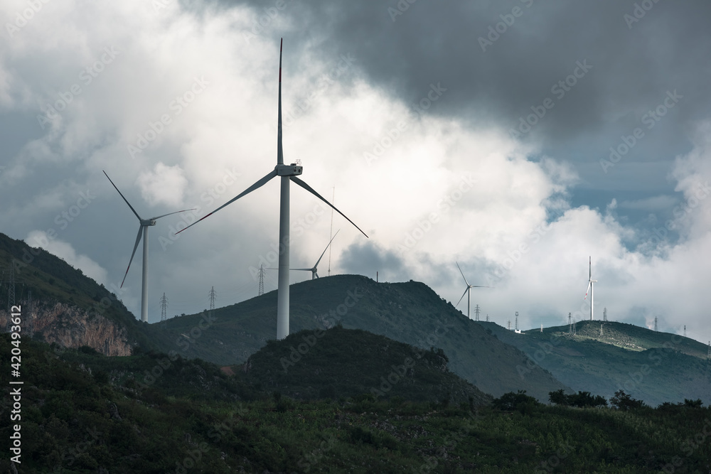 Wind turbines in the clouds on top of the mountain Wind turbines in the clouds on top of the mountain