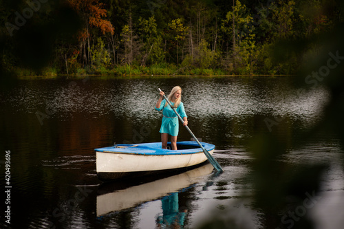 A woman riding on the back of a boat in a body of water