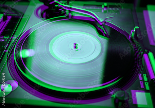 фотографія Retro dj turntable playing vinyl record disc with hip hop music on concert in ni
