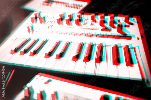 Photos Midi synthesizer keyboard in sound recording studio edited with retro 3D anaglyph effect