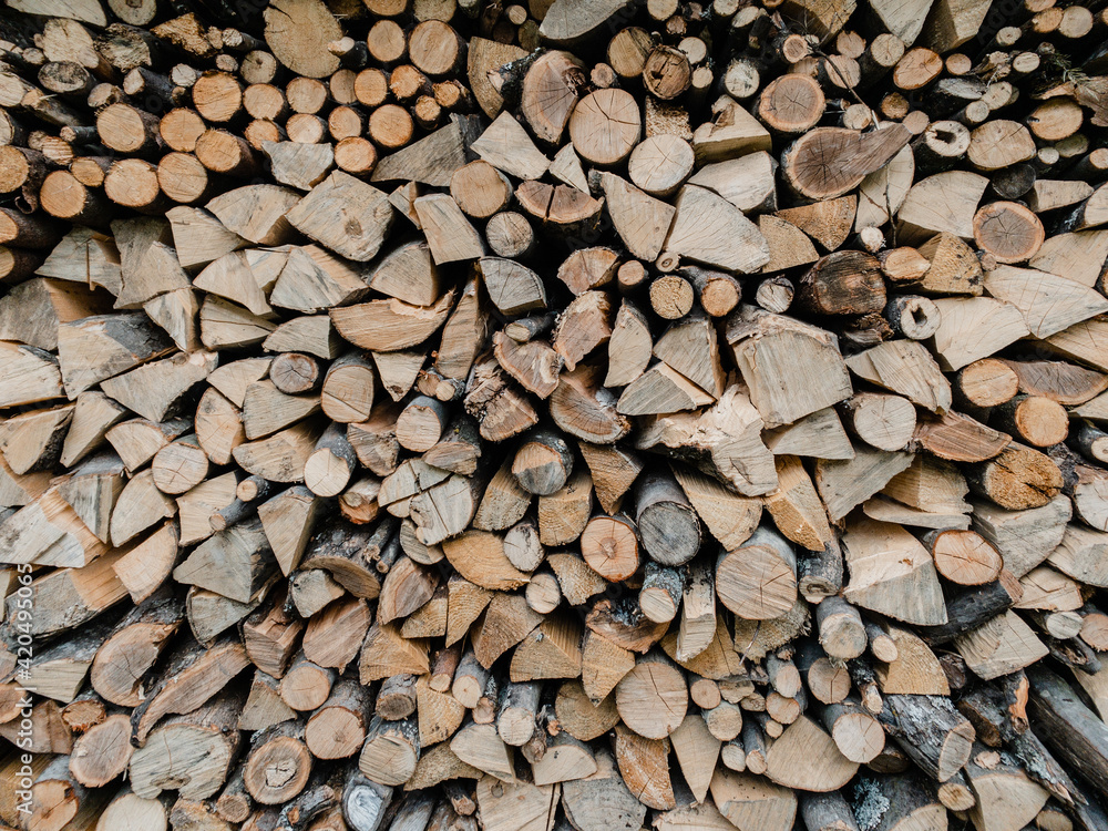The texture of chopped firewood lie against the wall The texture of chopped firewood lie against the wall