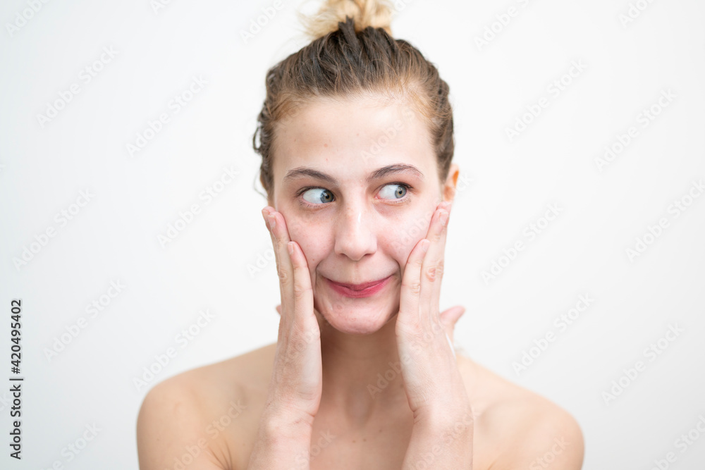 Happy Young Woman After Applying Cream on Her Face, Studio Shot on White Background Happy Young Woman After Applying Cream on Her Face, Studio Shot on White Background