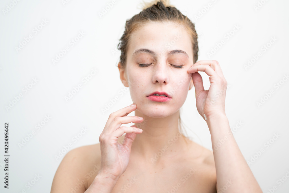 Fototapeta premium Happy Young Woman After Applying Cream on Her Face, Studio Shot on White Background