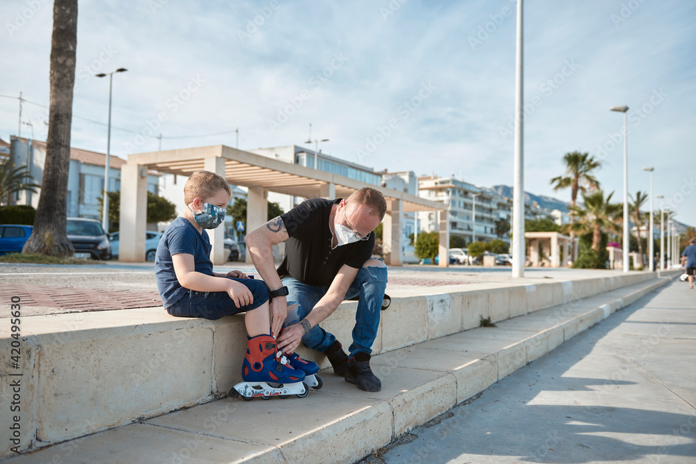 Father and son with roller skates Father and son with roller skates