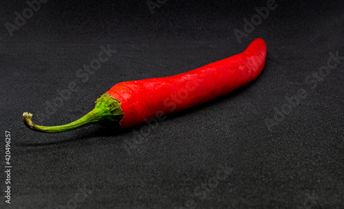 Red hot chili pepper on a black background.