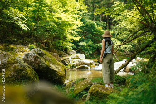 A Woman Visiting the Source of Yahagi River in Deep Forest in Nagano, Japan photo