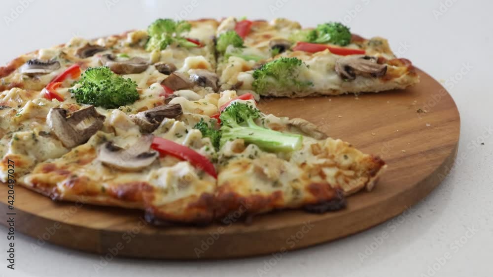 Grabbing a Slice of Vegetarian Pizza with Mushrooms, Peppers, Broccoli and Red Bell Peppers Grabbing a Slice of Vegetarian Pizza with Mushrooms, Peppers, Broccoli and Red Bell Peppers