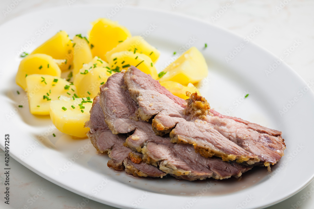 slowly roasted lamb on garlic with potatoes slowly roasted lamb on garlic with potatoes