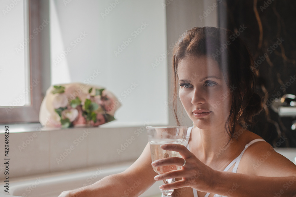 Young beautiful brunette girl in white underwear lies in the bathroom. Morning of the bride at the hotel in the bathroom. Young beautiful brunette girl in white underwear lies in the bathroom. Morning of the bride at the hotel in the bathroom.
