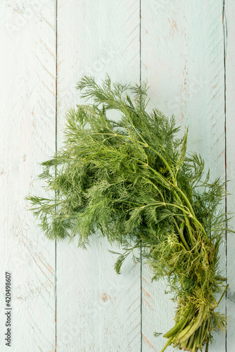 bunch of dill on the wooden table