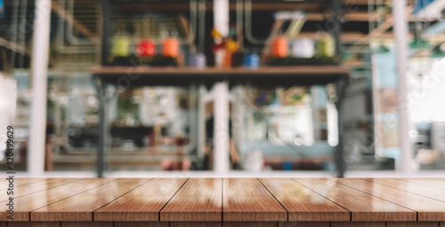 Empty wooden table top with lights bokeh on blur restaurant background