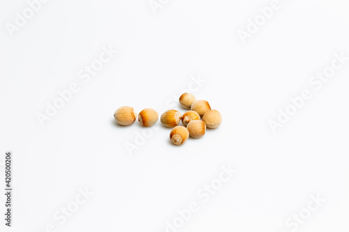 Nuts on a white background with an arrow shape on the right © LilianC