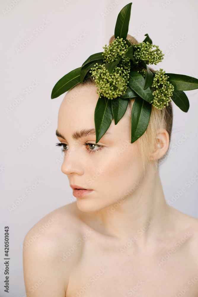 Sensual portrait of a young blond girl with a flower on her head Sensual portrait of a young blond girl with a flower on her head