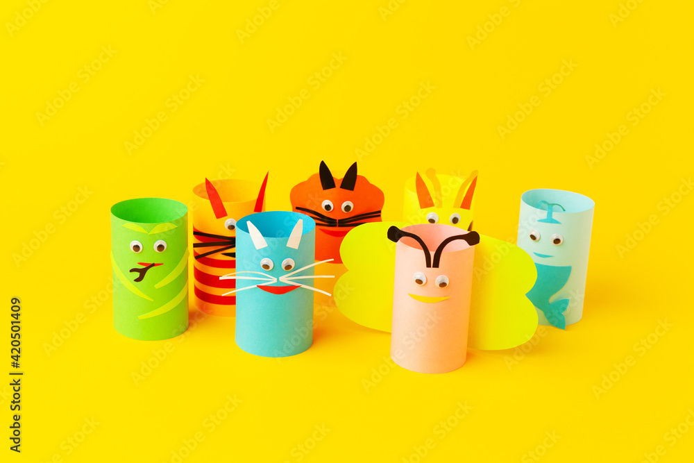 Fototapeta premium Handmade paper toys from toilet rolls, on yellow background.