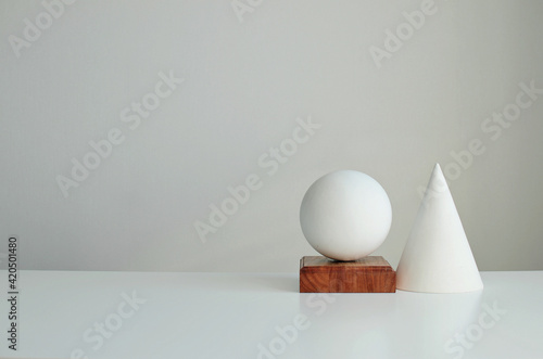 Stylish interior mockup with white geometric shapes of a ball and a cone