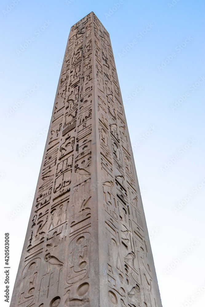 old obelisk with sculptural drawings in Luxor temple ,Egypt