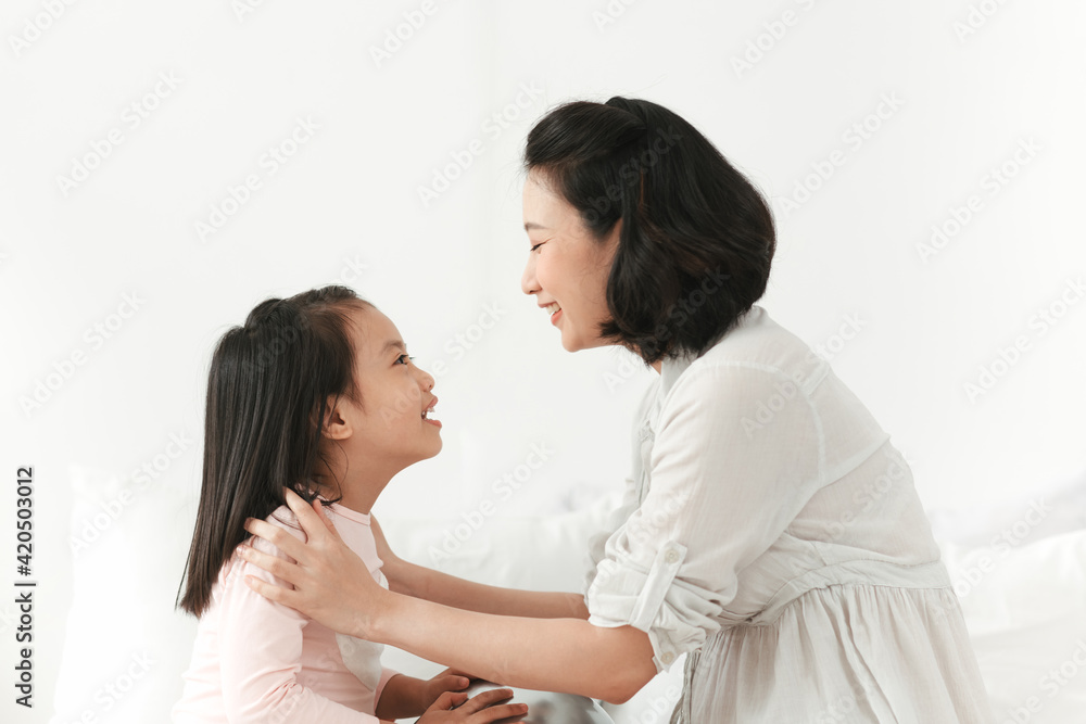 Young woman in the morning embrace with small girl. Young woman in the morning embrace with small girl.