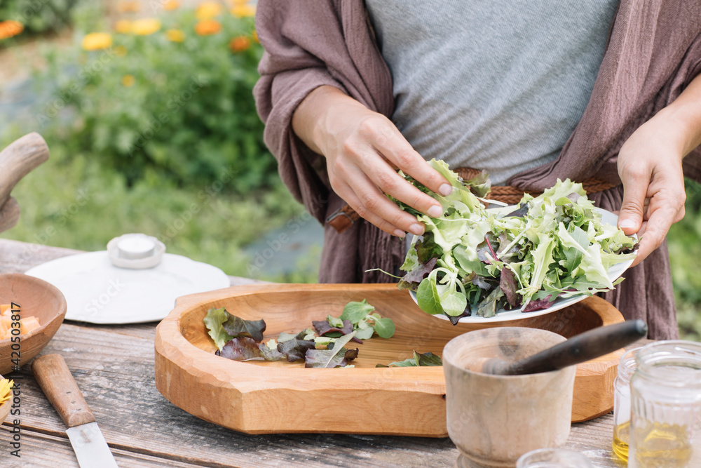 Anonymous Hand Making Fresh Salad With Wildflowers Anonymous Hand Making Fresh Salad With Wildflowers