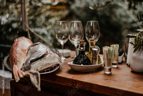 fish and two glasses of champagne on wooden table