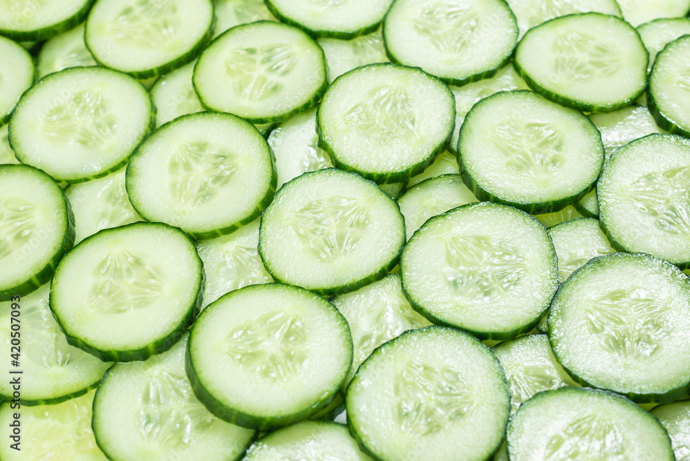 Fresh green slices of cucumber as background. Fresh green slices of cucumber as background.