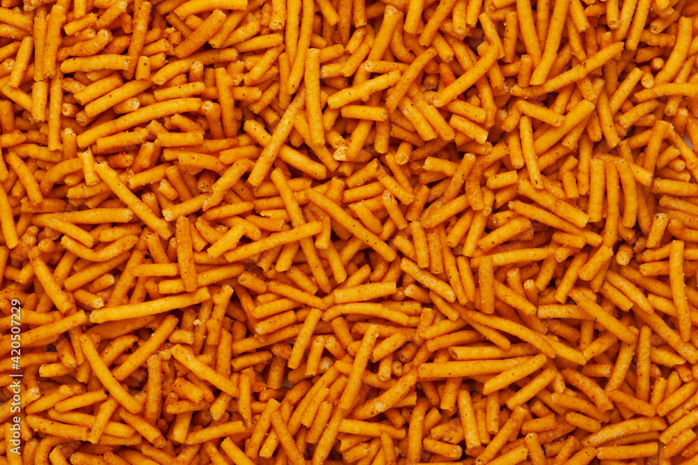 Close-up of Nimbu masala besan sev Indian namkeen (snacks) Full-Frame Background. Top View