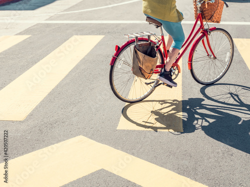 A woman on a red bicycle at Venice Beach, Los Angeles photo