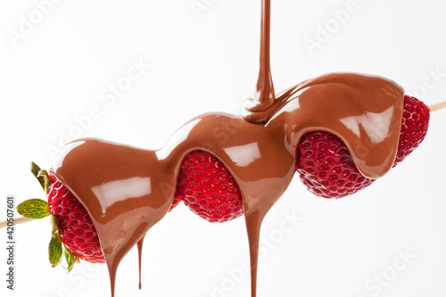 Strawberry skewer with melted milk chocolate
