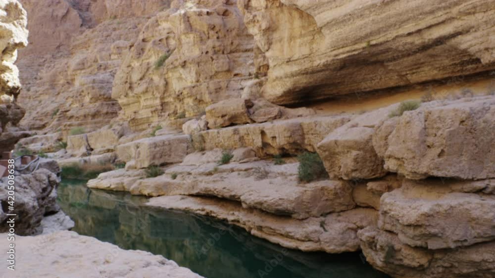 The turquoise pools of Wadi Shab canyon in Oman, handheld wide shot The turquoise pools of Wadi Shab canyon in Oman, handheld wide shot
