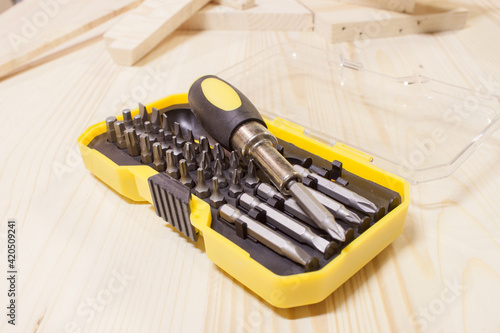 Drill bit kit, close up. 1-inch steel square driver bits in foreground. The kit is blue green with red driver sets. Beautiful defocused and abstract varieties of driver bit sets. Selective focus photo