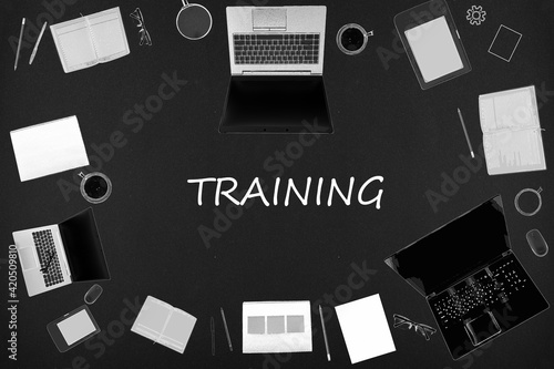 Training concept. Top layout of drawings of laptops, notepads, coffee, different business stuff on black background.