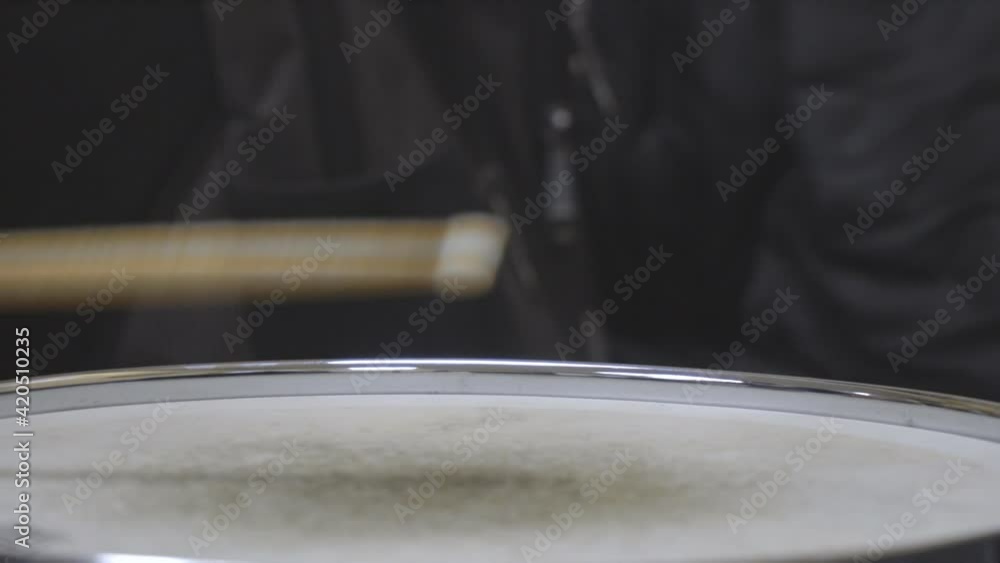 The drummer drumming with his sticks on the snare drum The drummer drumming with his sticks on the snare drum