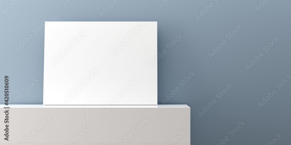 White empty poster or picture mock-up template on white sideboard in front of blue wall background