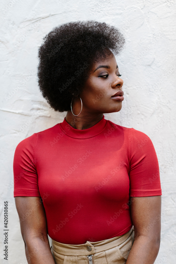 Portrait of attractive black woman in red looking to the side Portrait of attractive black woman in red looking to the side